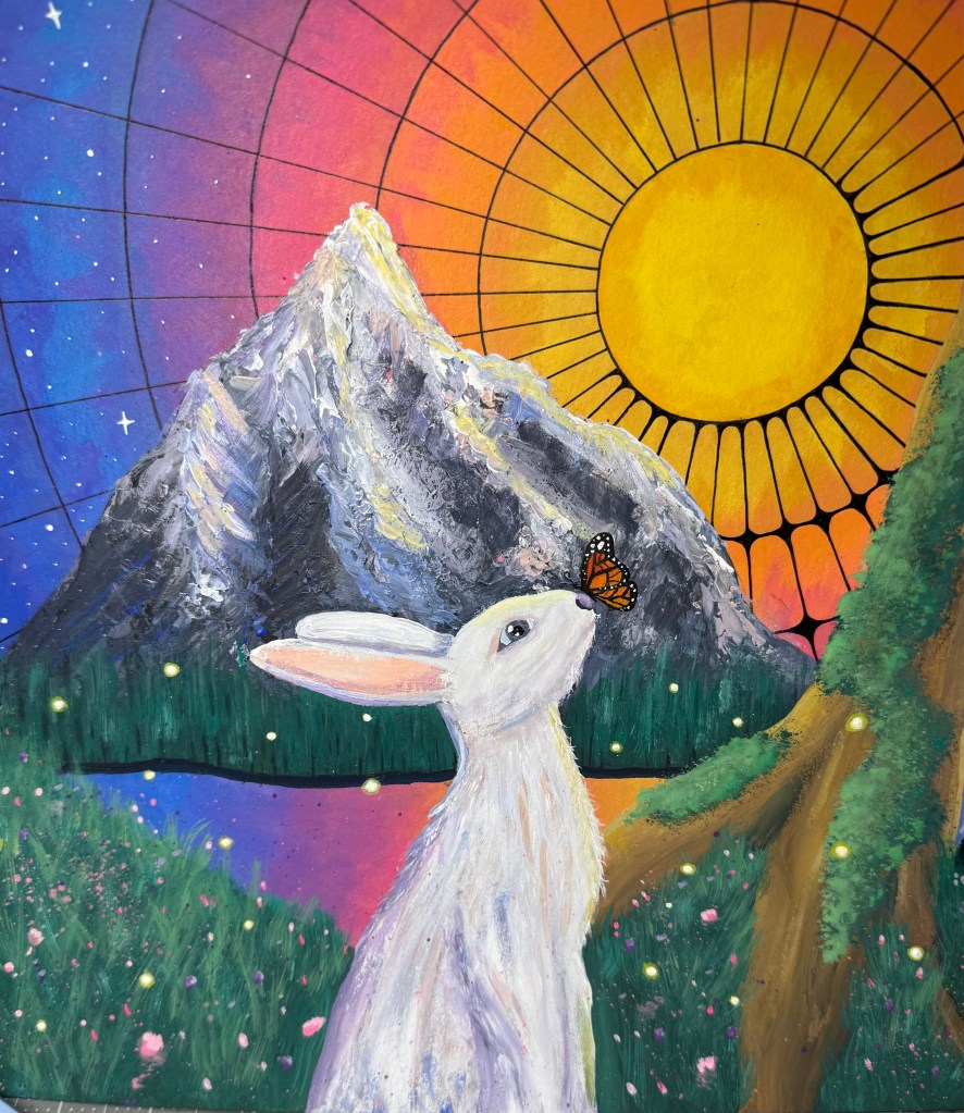 A white rabbit with a monarch butterfly on its nose before a mountain and a radiant sun